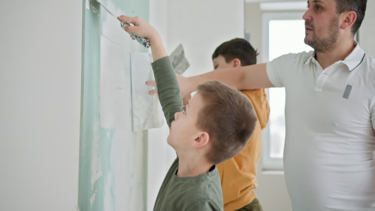 Father and Sons Repairing a Wall