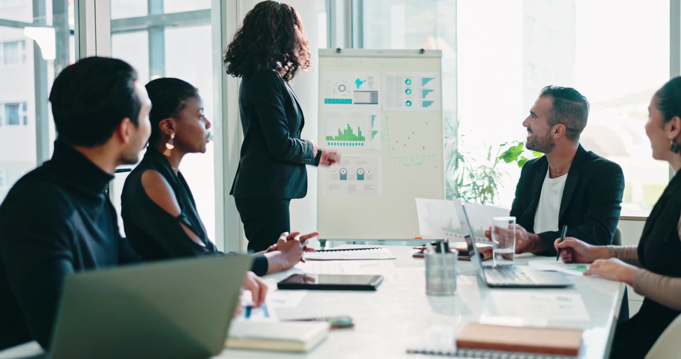 Businesswoman Presenting Growth Strategy to Team in Modern Office