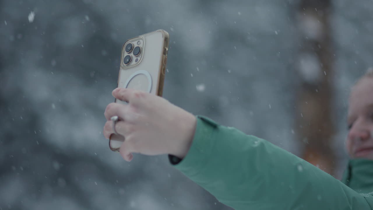 Happy girl taking a selfie in the snow