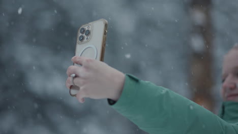 happy girl taking a selfie in the snow