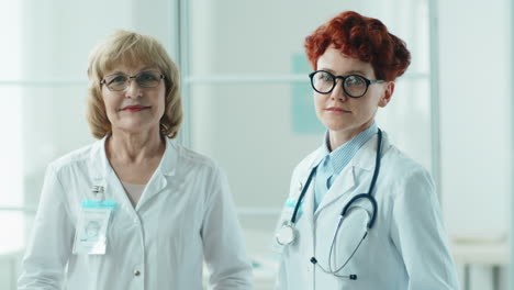 Portrait-of-Senior-and-Young-Female-Doctors-in-Clinic