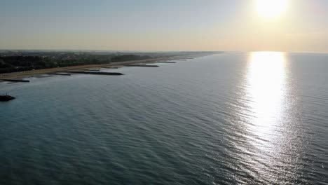 Aerial-shot-of-a-peaceful-scene-after-sunrise-on-the-coast-of-Caorle-near-Venice,-Italy