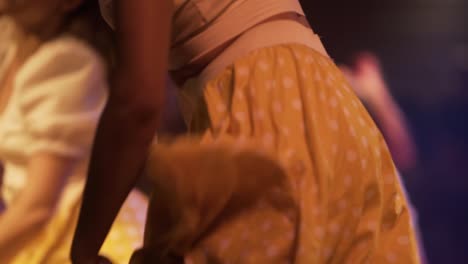 girls-dancers-dancing-joyfully-with-yellow-skirts-at-Cuba,-exotic-dancers-close-up