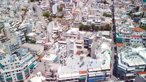 Drone-shot-of-Pireaus-in-Greece-above-city-buildings-during-a-sunny-day