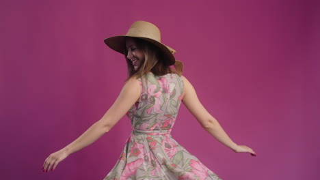 woman in a floral summer dress and straw hat