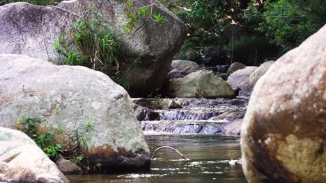 Clear-brook-rapids-among-boulders,-scenery-of-water-flowing-with-tranquility