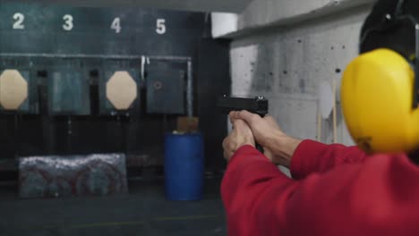 person practicing pistol shooting at the range