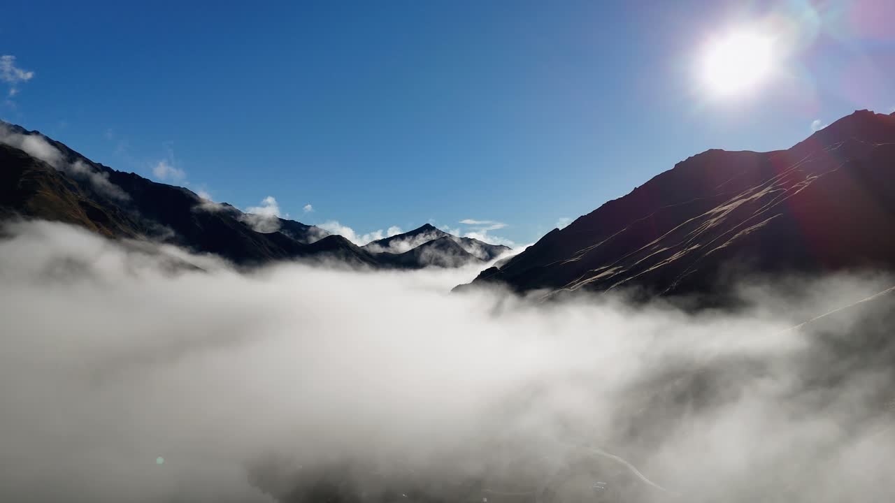 Drone captures sunrise over misty mountain landscape