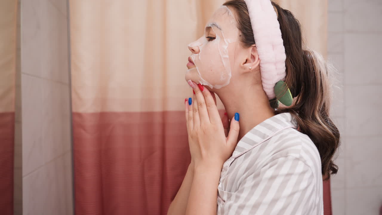 Gentle Facial Massage In Bathroom Setting, Nighttime Skincare Routine With Calming And Glowing Effects, Relaxing Beauty Ritual Performed Near Shower With Soothing Touch And Serene Reflection