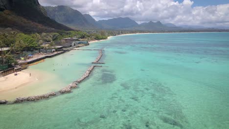 drone footage of the stone breakwater on the coast of hawaii island