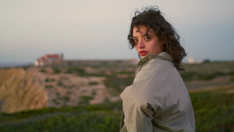 Smiling-woman-posing-evening-vertical-shot.-Carefree-lonely-tourist-enjoy-calm