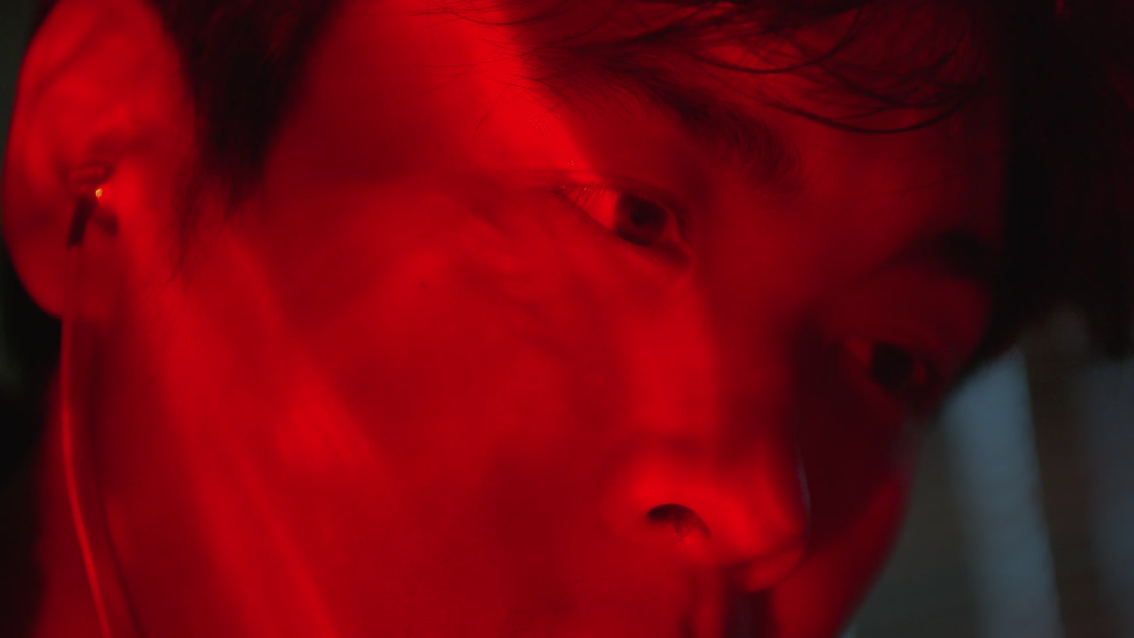 Close-up Portrait of a Young Man in Red Light