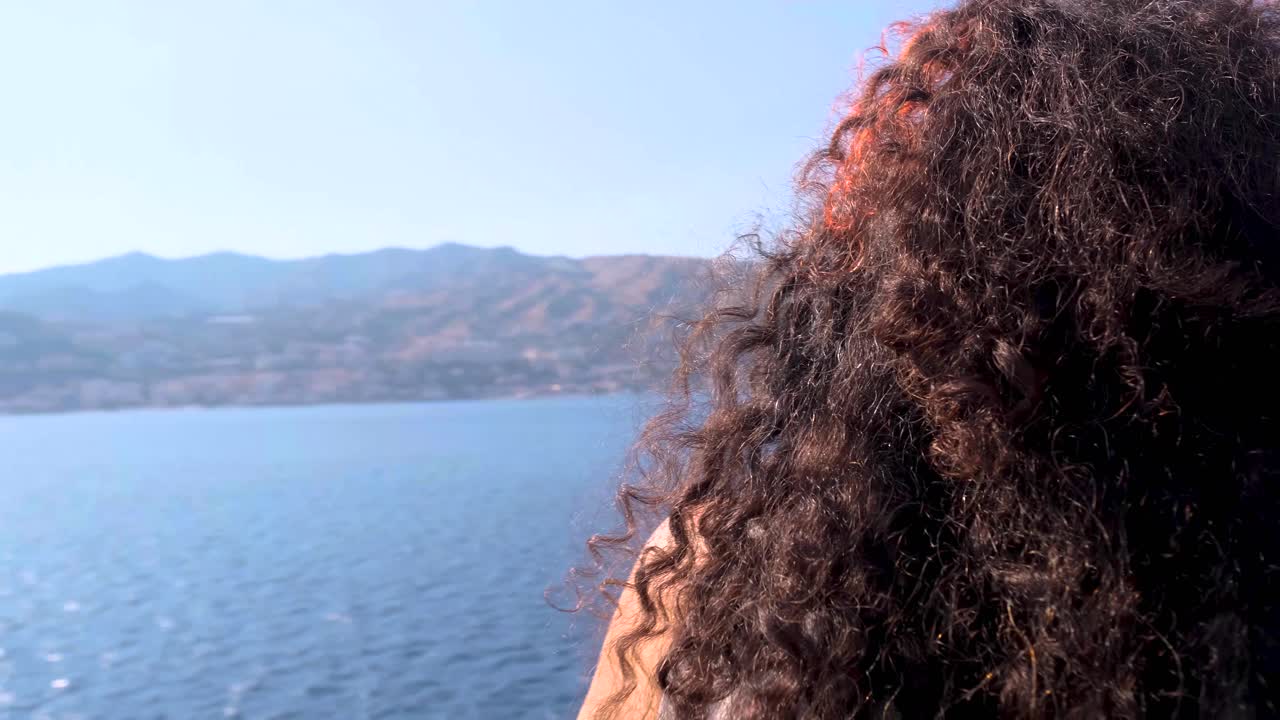 Stabilized Slow Motion Close Up Circling Shot of Young Tan Lebanese Woman with Nose Piercing and Dyed Hair Soaking in View of Sicily from Ferry Boat