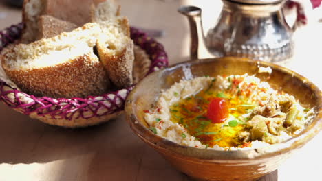 delicious moroccan couscous meal served with oil and bread, shallow focus push in across table setting