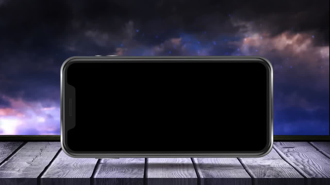 animación de pantalla de teléfono inteligente negro en superficie de madera con fuegos artificiales explotando en el fondo