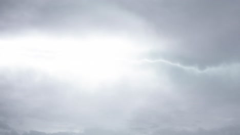 time-lapse lightning strike during a thunderstorm in gray clouds