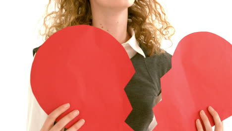 in slow motion geeky hipster holding a broken heart card