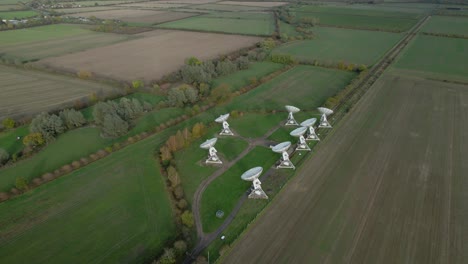 aerial view rising over mullard mrao radio observatory telescope cluster on cambridge countryside