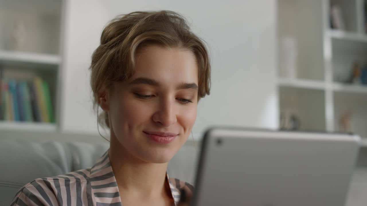 Girl finishing video call talking on sofa closeup. Cute blonde using tablet.