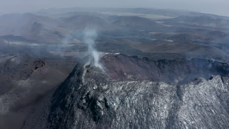 Fly-above-volcanic-landscape-after-eruption.-Aerial-view-of-smoke-coming-from-volcano.-Fagradalsfjall-volcano.-Iceland,-2021