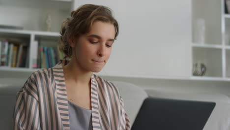 Thinking-manager-working-home-on-laptop-closeup.-Cute-lady-in-pajamas-send-email