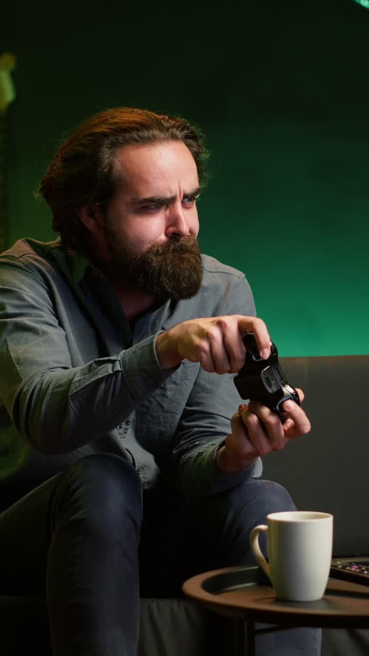 Vertical video Focused man playing videogame in neon illuminated home