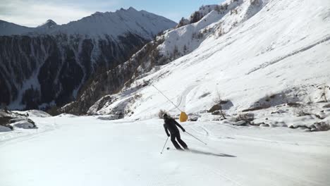 Skier-slowly-making-turns-on-a-clean-white-slope-in-the-Austrian-alps