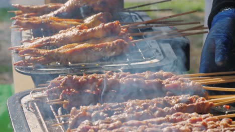 pork meat skewer on fire, mutton barbecue close-up. fried meat for kebab. cooking grilled meat beef chicken lamb bbq . kebab on grill. chinese street local market with traditional food. asian fast food.