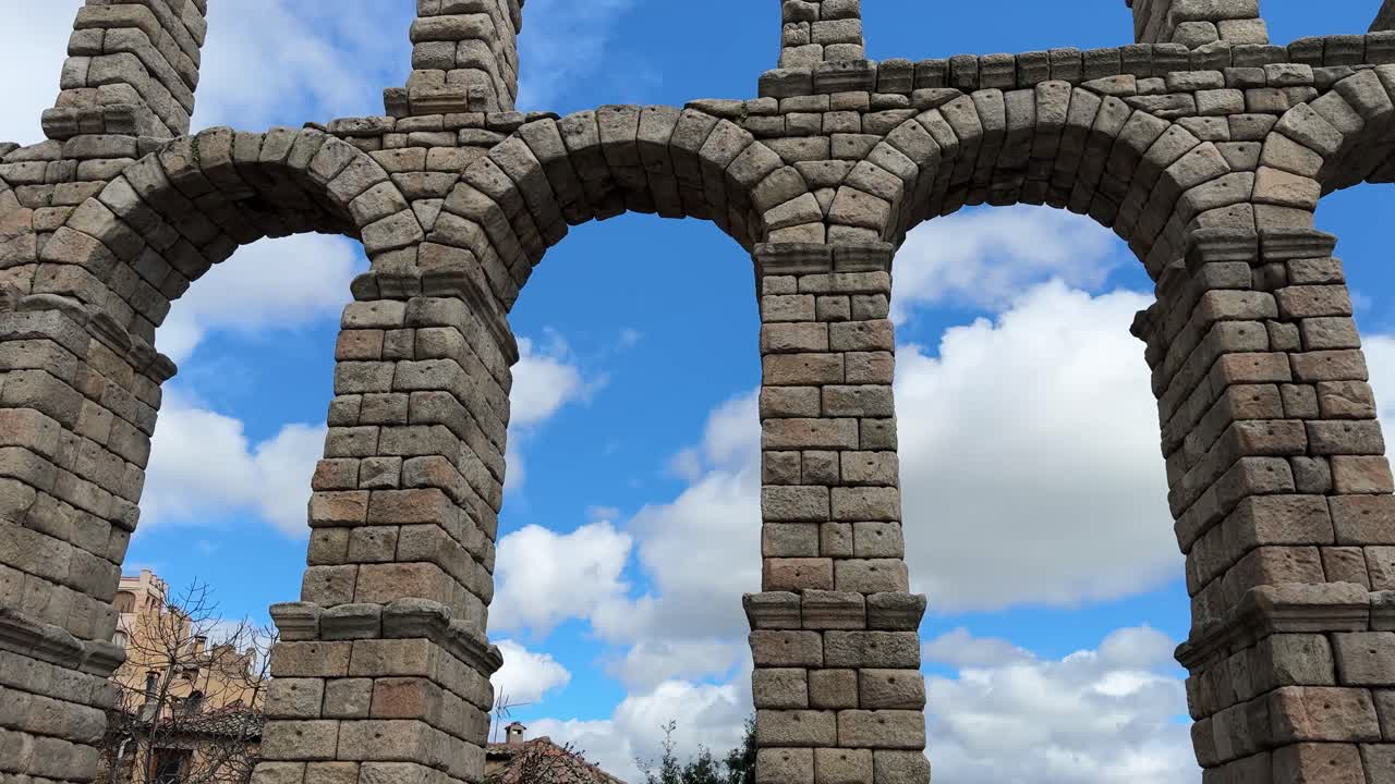 Historic Aqueduct in Segovia, a Roman architectural marvel in sunlight.