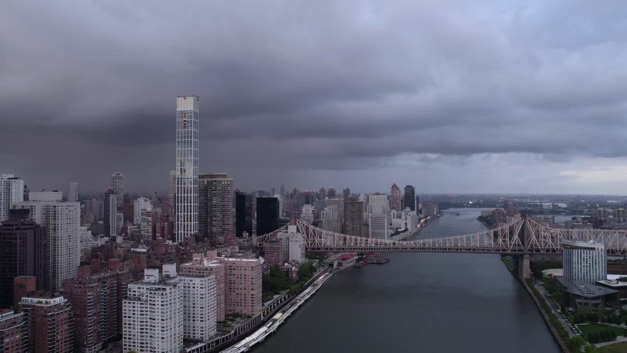 Queensboro Bridge.and the Midtown East cityscape, in NYC, USA - circling Aerial