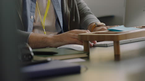 close  up hands caucasian businessman using computer typing browsing online research working in startup office brainstorming