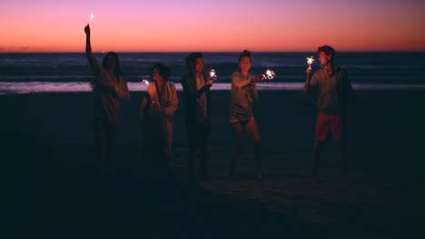 friends celebrating at sunset beach