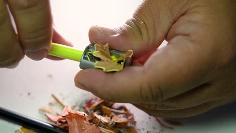 Footage-of-hands-slowly-sharpening-a-pencil-and-some-coloured-pencils-with-a-Wedge-Pencil-Sharpener