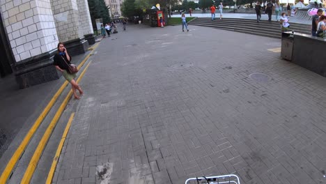 city street scene with pedestrians and a baby stroller