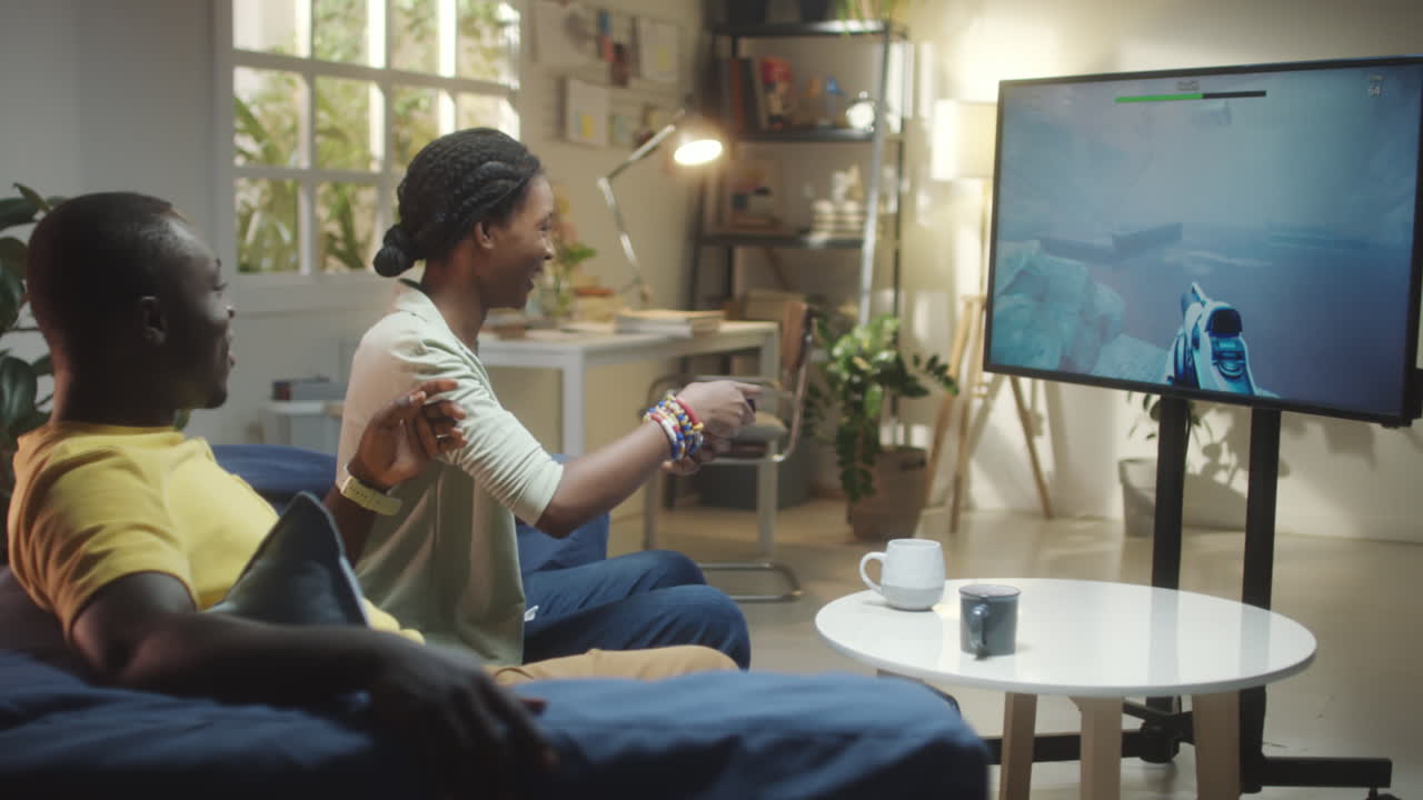 Couple or Friends Playing Video Games in Living Room