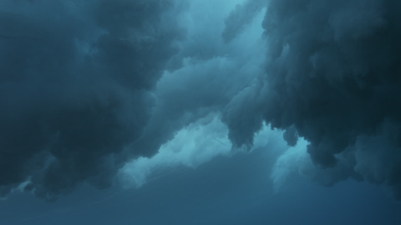 Dark underwater wave turbulence forming dense foam and moody deep ocean atmosphere