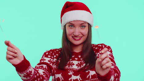 lovely girl in christmas santa sweater dancing with bengal sparklers fireworks ligts, congratulation