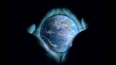 3d animation: men's hands holding the rotating planet earth with a blue glow on a black background. seamless loop. the concept of divine power, support, and the fragility of the world. faith, religion