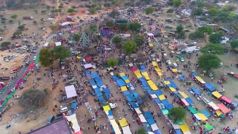 Zoom-in-aerial-view-of-fun-fair-in-the-outskirts-of-Jaipur-Rajasthan,-India