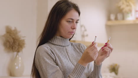 Woman-Quitting-Smoking-While-Holding-A-Broken-Cigarette-At-Home