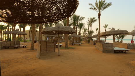 Luxury-sand-beach-with-beach-chairs-and-umbrellas-in-a-tropical-resort-in-the-Red-Sea-coast,-Egypt,-Africa