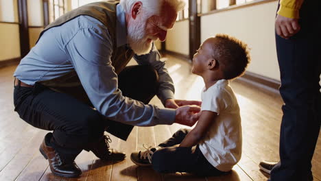 a grandfather and grandchild share a loving moment indoors