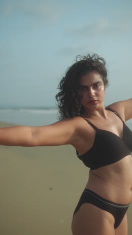 a woman walking on a beach, enjoying the warm sun, with a relaxed and carefree mood