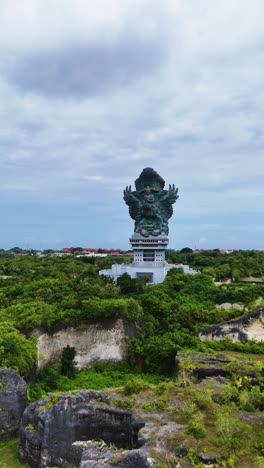 vertical aerial panroamic view of garuda wisnu kencana statue
