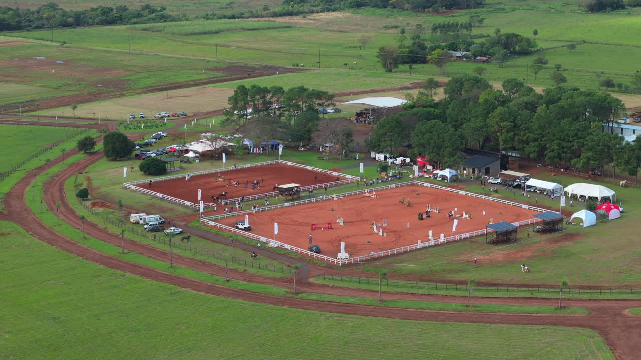 Aerial view Equestrian center with jumping arenas and training zones, rural paths and event setup