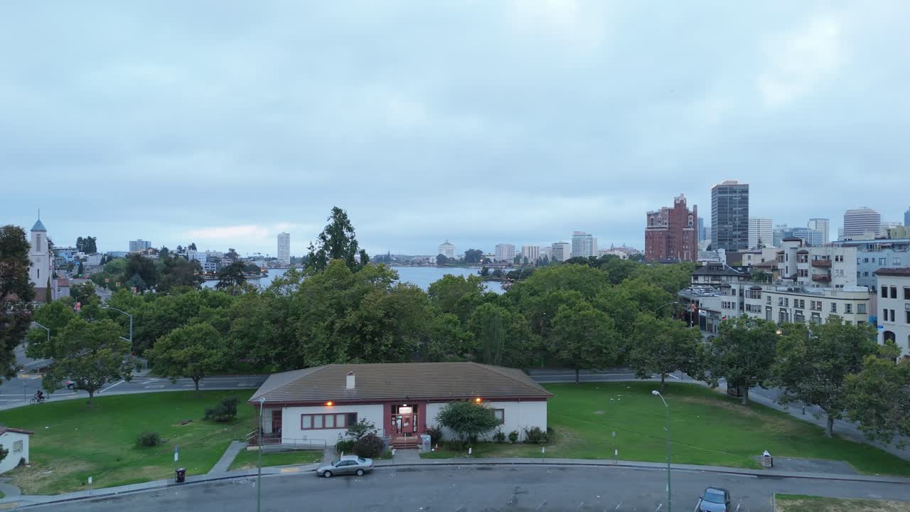 Early morning light casts soft tones across Lake Merritt, framed by parks and downtown architecture