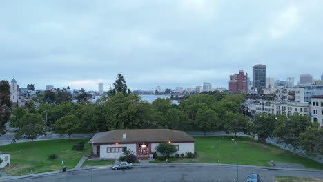 early morning light casts soft tones across lake merritt, framed by parks and downtown architecture