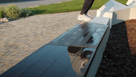 person jumping over bench in urban park