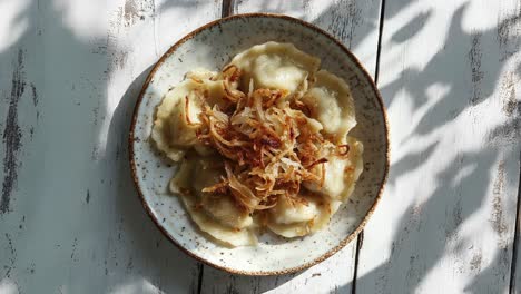 deliciosos pierogi caseros con cebollas fritas y crujientes