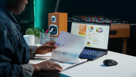 businesswoman analyzing data on laptop